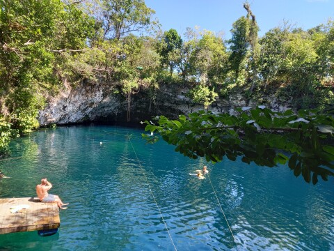 big lake with blue water surrounded by rocks and trees