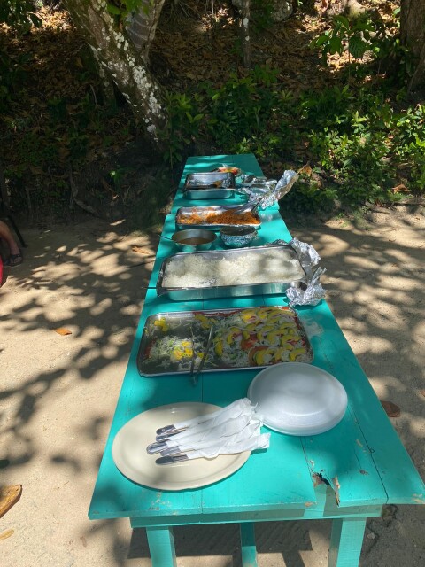 wooden table at the beach with lunch dishes