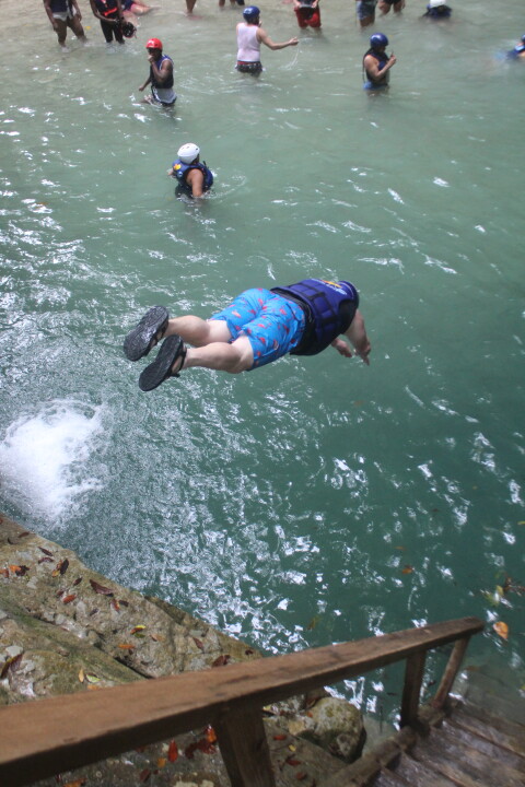 man diving down from a rock
