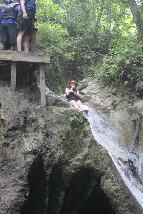 Jong woman ready to use the rock slide in the waterfalls